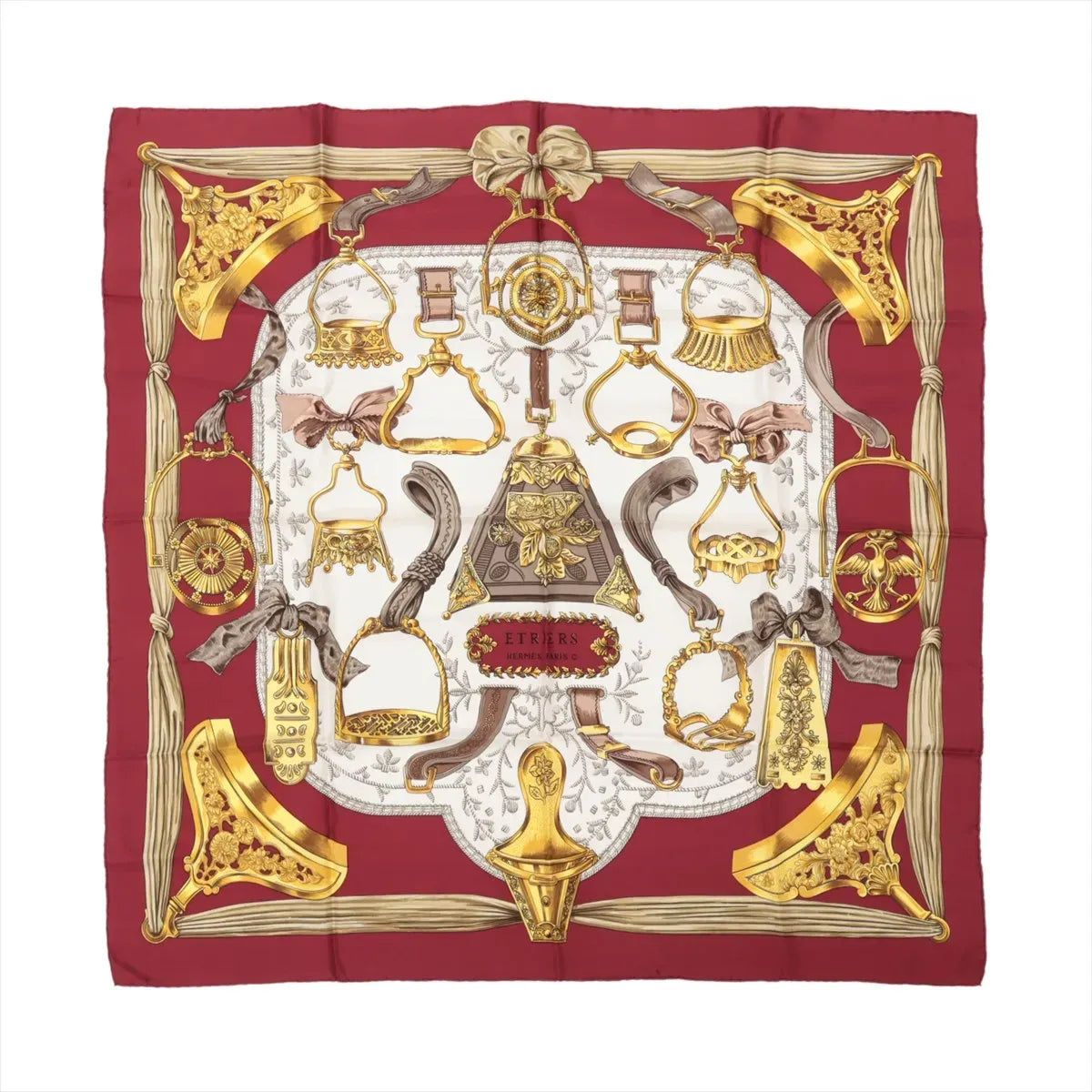 Hermès Carré 90 "Étriers" Silk Scarf in red, featuring detailed golden stirrup and equestrian motifs arranged symmetrically on a white center background, bordered with deep red edges and intricate ribbon-like accents.