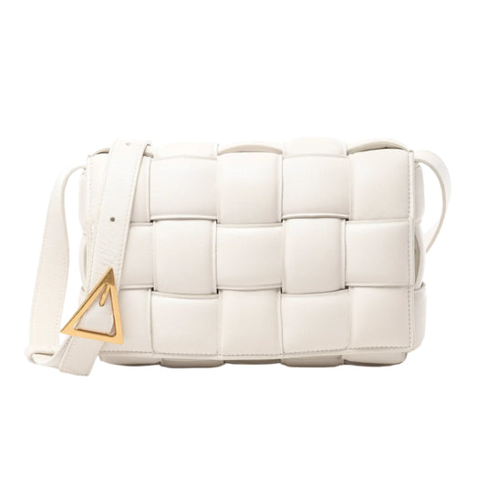 Front view of Bottega Veneta Padded Cassette Maxi Intrecciato Leather Shoulder Bag in ecru with oversized woven leather panels, adjustable strap, and gold-tone triangle buckle, displayed against a white background