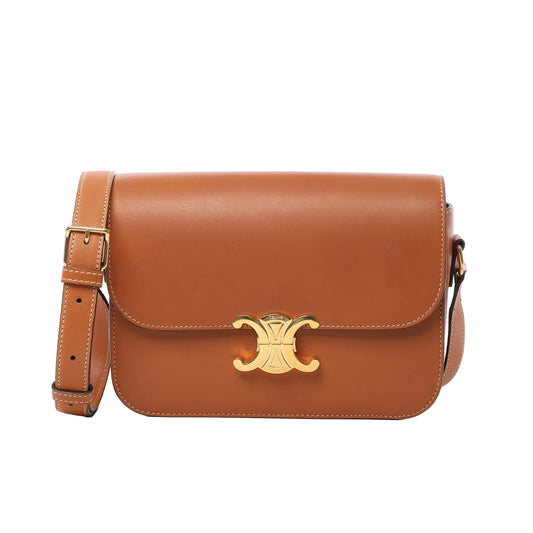 Front view of Celine Triomphe Classic Leather Shoulder Bag in brown, featuring smooth leather finish, gold-tone Triomphe clasp, adjustable shoulder strap, and contrast stitching against a white background.