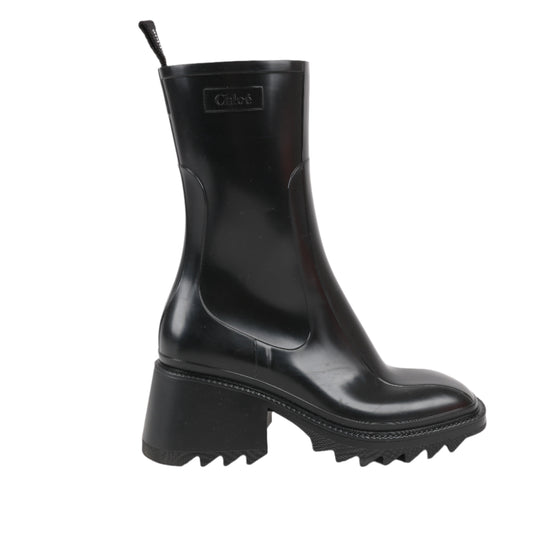 Black rubber boot with a brand logo on a white background