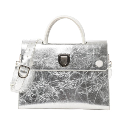 Front view of Christian Dior Diorever Medium Leather 2Way Handbag in metallic silver, featuring a structured design, top handle, detachable shoulder strap, and signature Dior clasp closure against a white background.
