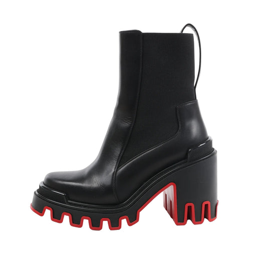 Christian Louboutin Marsha Cloche black leather ankle boots with elastic side panels, chunky high heel, and dramatic red lug sole, shown in a side profile on a white background.
