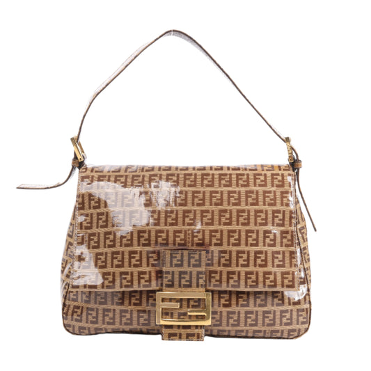 Designer handbag with a clear plastic bag on a white background