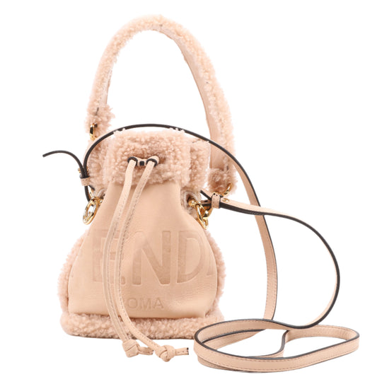 A powder beige Fendi Mon Tresor Mini Mouton 2Way Shoulder Bag made of leather, featuring a shearling trim, a top handle, and a detachable strap.