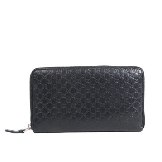 Black Gucci textured wallet on a white background