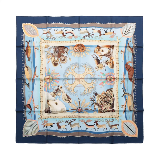 Hermès Carré 90 "LA VIE DU GRAND NORD" silk handkerchief in navy blue, featuring a detailed scene of Arctic animals, Inuit figures, polar bears, and natural motifs on a light blue background, bordered with stylized leaves and wildlife patterns, printed on fine silk.