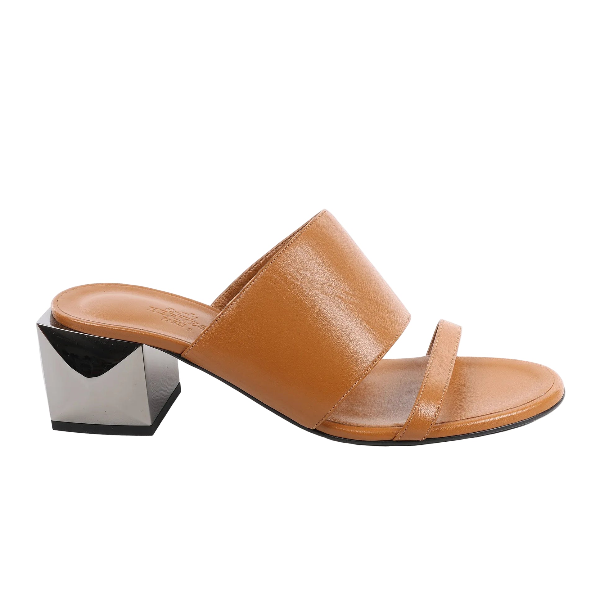 HERMES Cornelia sandals in brown leather with wide and slim front straps, paired with a sculptural metallic square block heel, displayed in side profile on a white background.