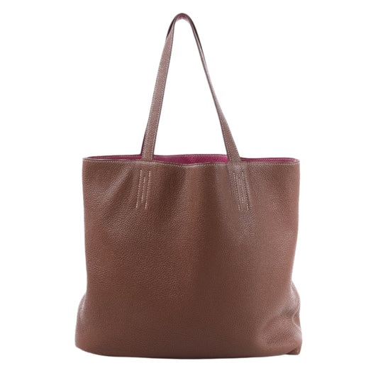 Brown leather tote bag on a white background