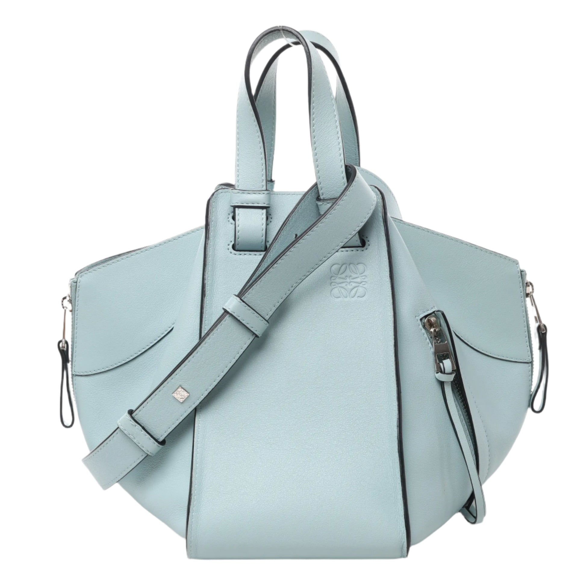 Front view of LOEWE Hammock Small Leather 2Way Handbag in light blue smooth leather with top handles, side zip details, and adjustable shoulder strap, displayed against a white background.
