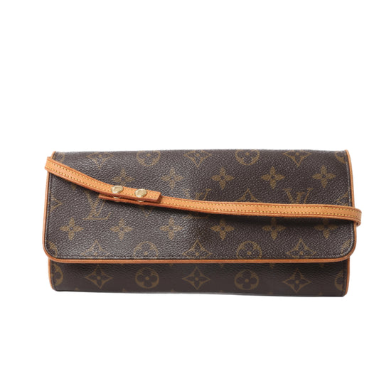 Front view of Louis Vuitton Monogram Canvas Pochette Twin GM Shoulder Bag M51852 with brown monogram pattern, natural leather trim, and thin adjustable strap, displayed against a white background.