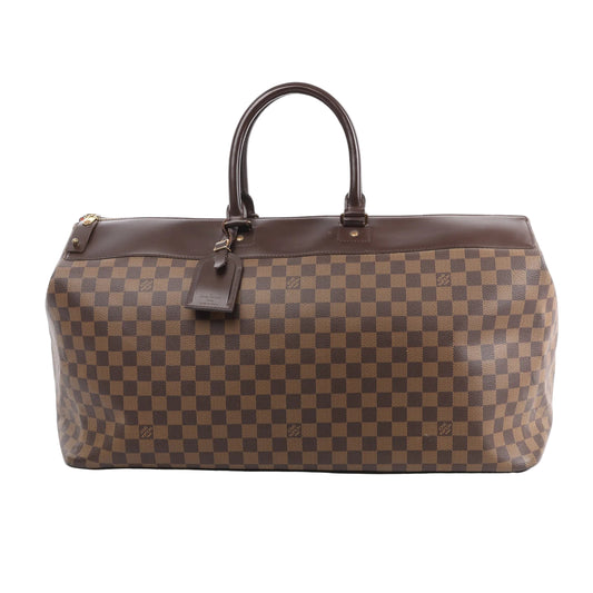 Louis Vuitton Greenwich GM travel handbag in Damier Ebene canvas with dark brown leather trim, dual top handles, gold-tone hardware, and a hanging luggage tag, shown against a white background.