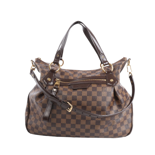 Brown checkered handbag with gold accents on a white background