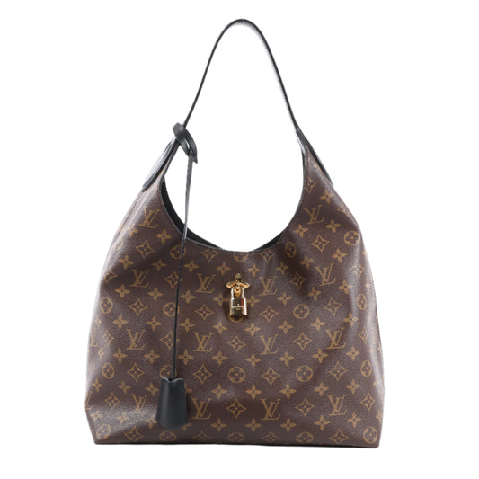 Brown handbag with gold monogram pattern on a white background