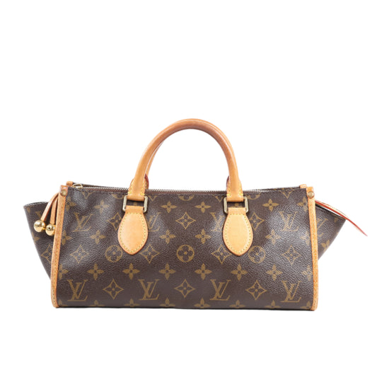 Brown handbag with tan leather handles and accents on a white background