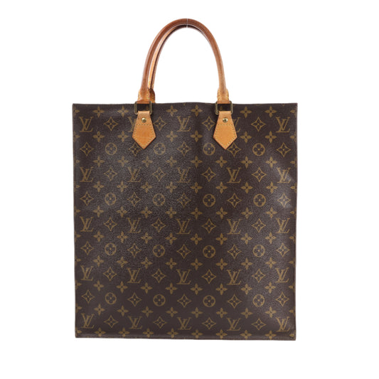 Designer handbag with monogram pattern on a white background