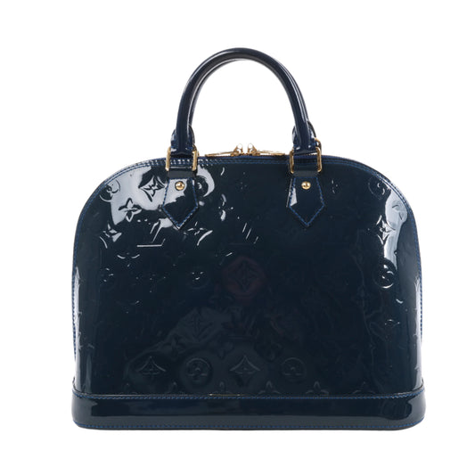 Navy blue patent leather handbag with gold hardware on a white background