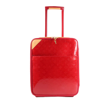 Red suitcase with gold accents on a white background