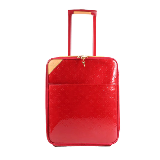 Red suitcase with gold accents on a white background