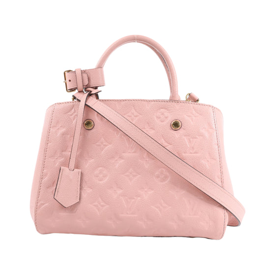 Pink handbag with a strap on a white background