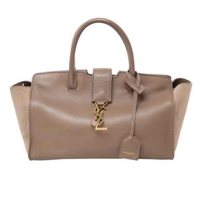Front view of Saint Laurent Paris Downtown Cabas handbag in brown leather and suede, featuring gold YSL logo hardware, dual top handles, and structured silhouette against a white background.
