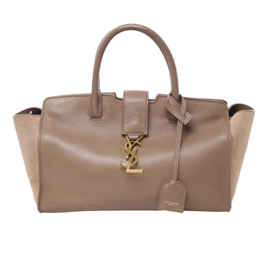 Front view of Saint Laurent Paris Downtown Cabas handbag in brown leather and suede, featuring gold YSL logo hardware, dual top handles, and structured silhouette against a white background.