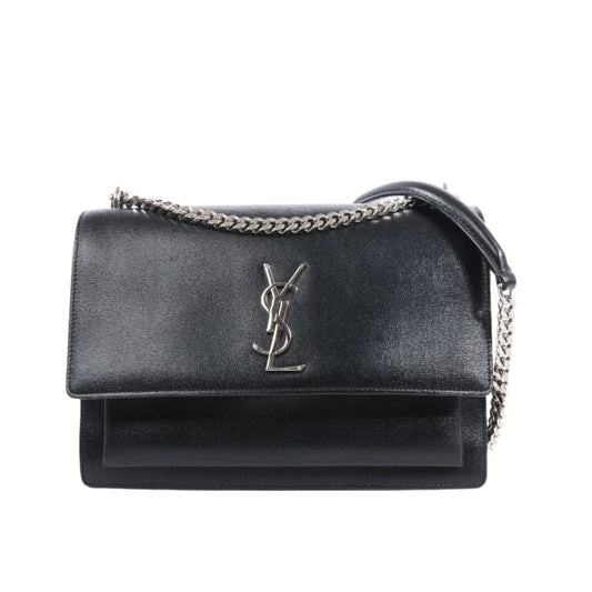 Black handbag with chain detail on a white background