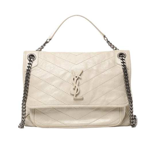 Front view of Saint Laurent Paris Niki Medium Chain Shoulder Bag 633158 in ecru crinkled leather with chevron quilting, tonal YSL logo, and silver-tone chain strap, displayed against a white background.