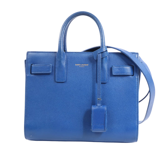 Blue handbag with a strap on a white background